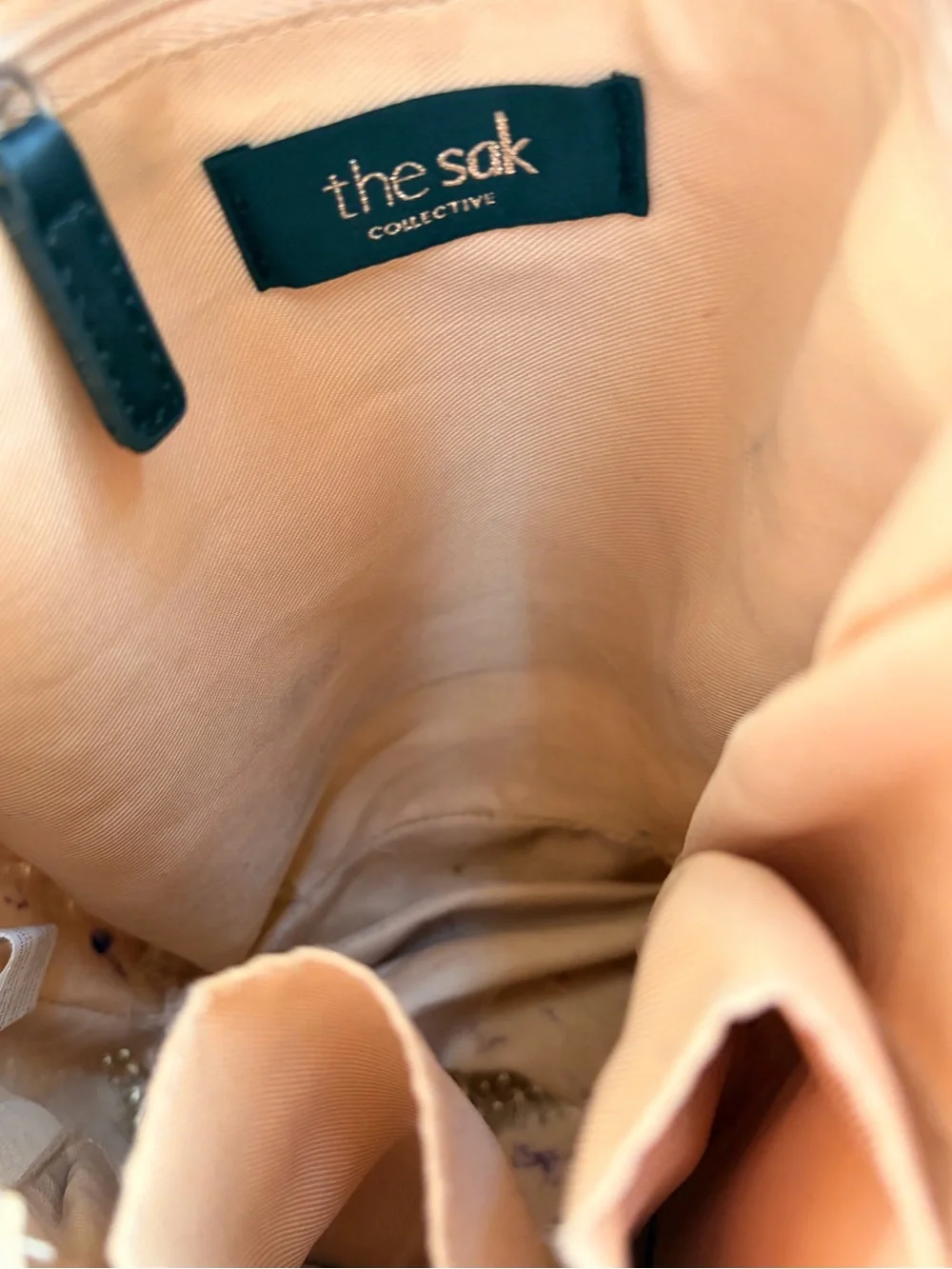 The Sak Silver Round Logo Tag on Cream Braided Accent